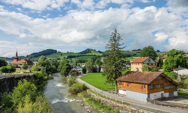 Sitter River in Appenzell village, Switzerland, Europe. Appenzell Innerrhoden is Switzerland's most traditional and smallest-population canton (second smallest by area). Appenzell is known for rural customs and traditions such as the ceremonial descent of cattle in autumn, as well as hiking tours in the scenic Alpstein region.